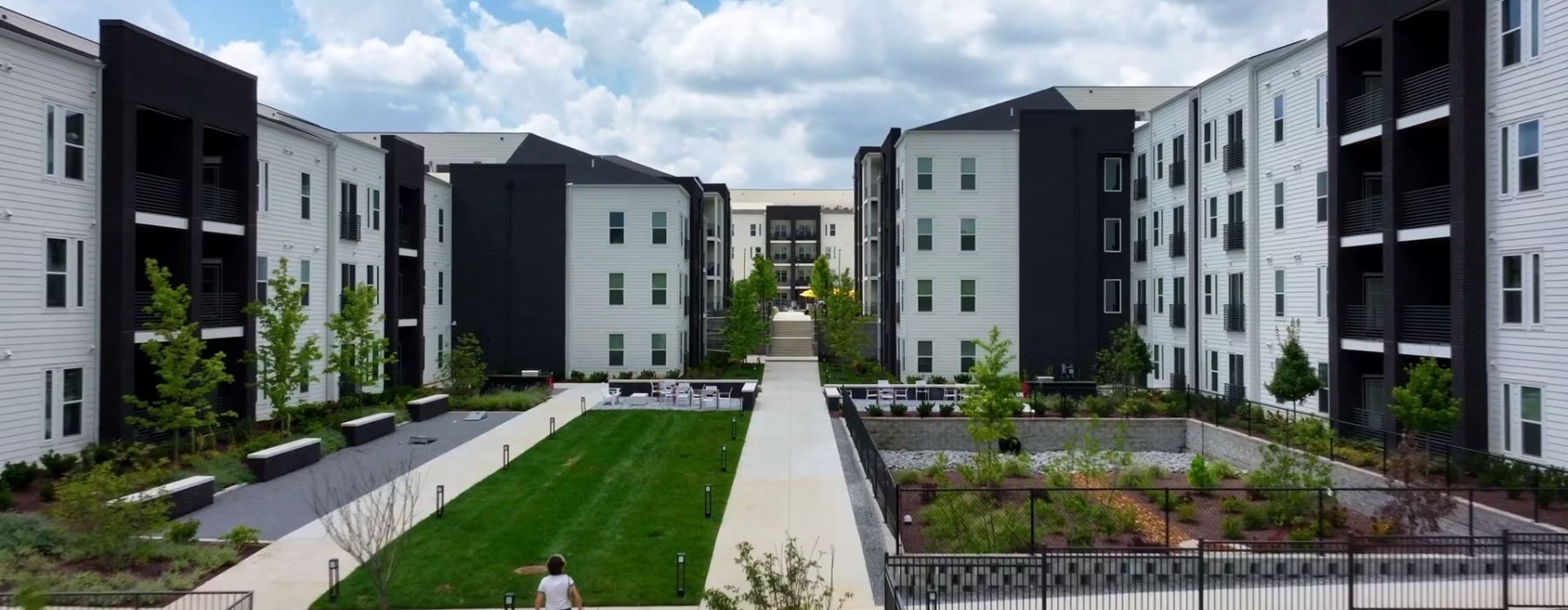 a person walking in green courtyards