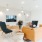 a room with a sofa, chairs and a tv